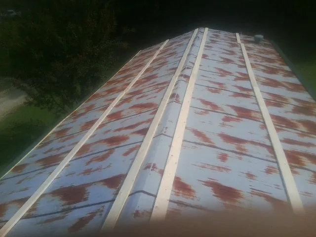 Rusted metal roof panels with new wood purlins before replacement — Storm Damage Roof Repair in Moscow Mills by Roofing Brothers