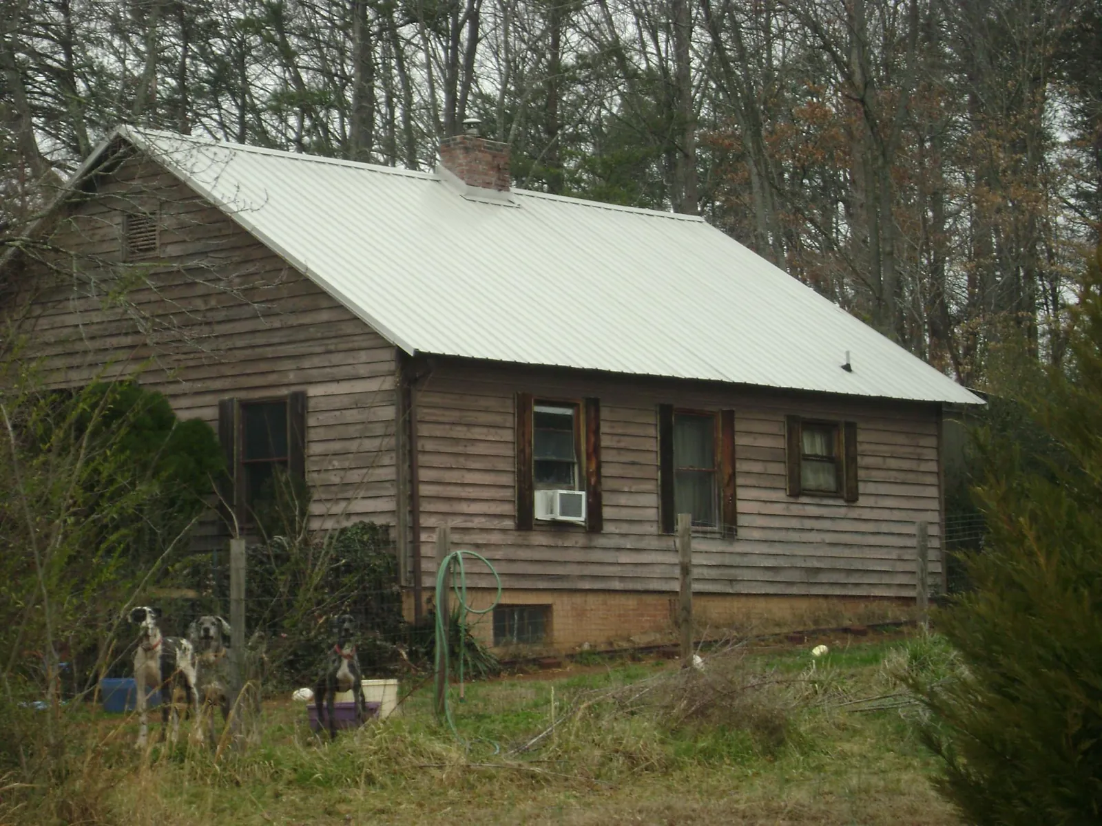 White metal roof on an old wood sided farmhouse, from a Metal Roof Installation job in Moscow Mills